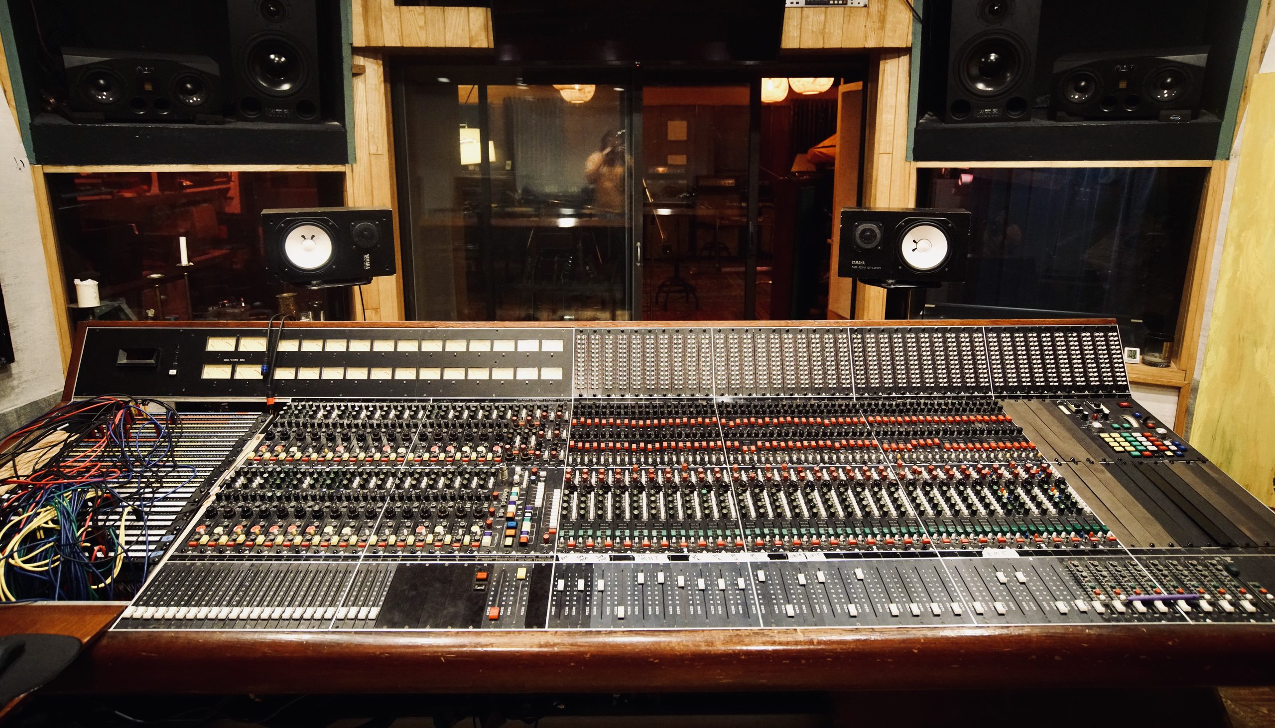 DRP control room — head-on view of the Trident TSM 40 console with the live room visible through the glass behind it